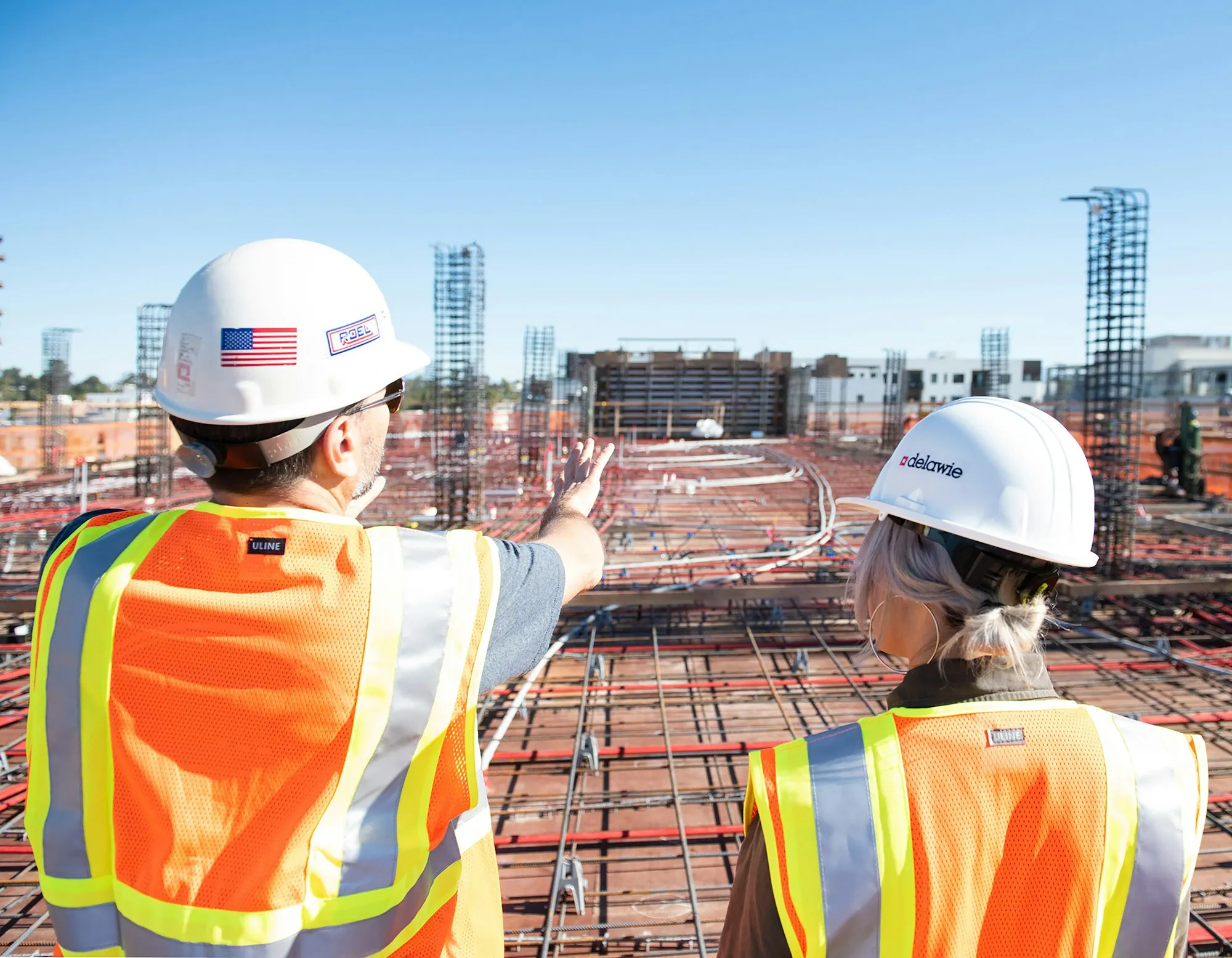 Site supervisors in hard hats discussing a project
