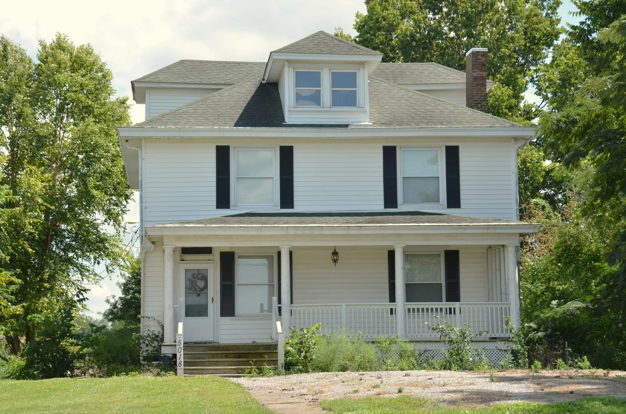 White colonial house with black shutters