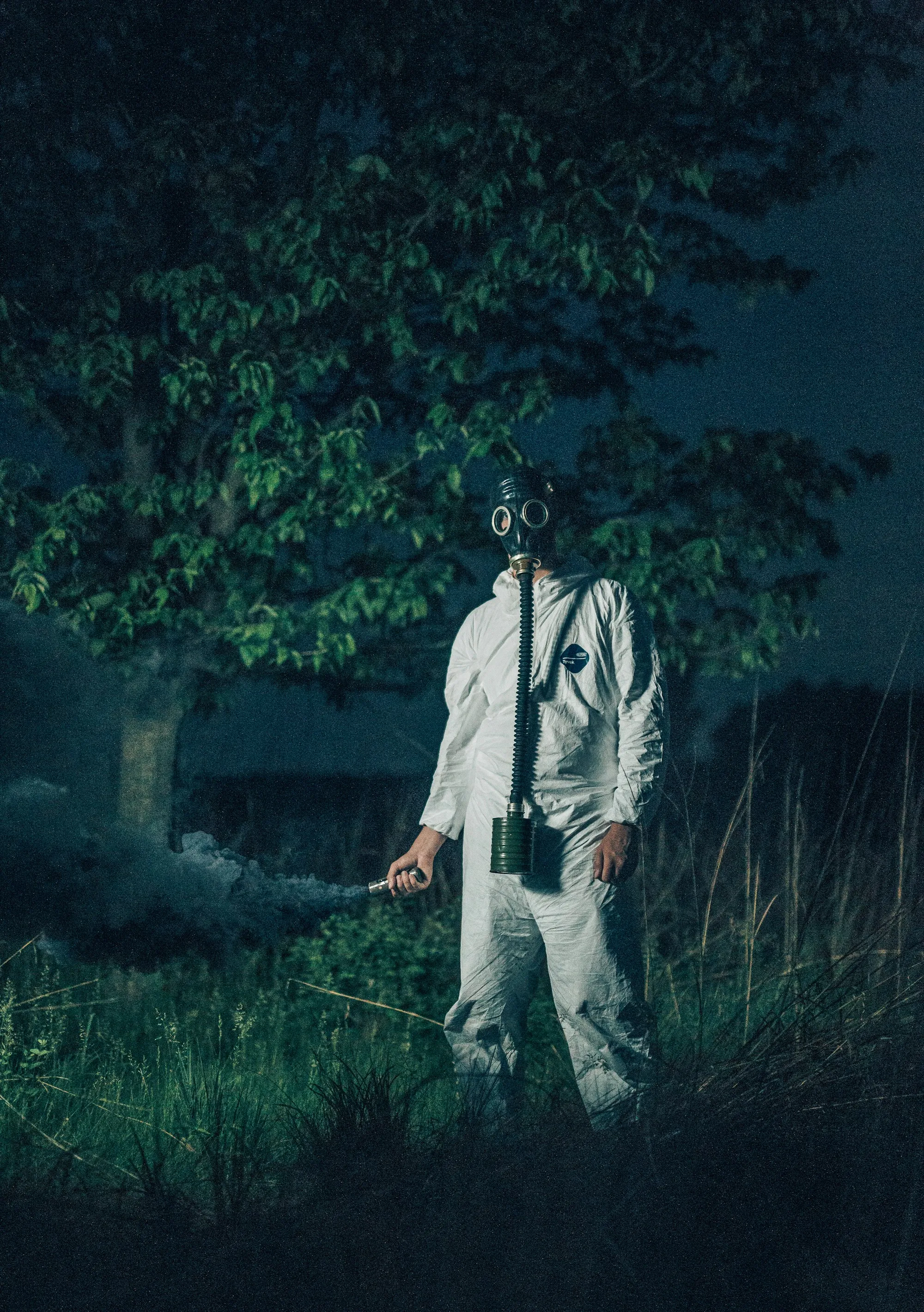 Worker in a full protective suit and respirator outdoors